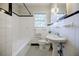 Tiled bathroom with black and white accents, shower, and pedestal sink at 2007 Mount Vernon Pl, Dunwoody, GA 30338