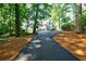 Long driveway leading to a charming house surrounded by tall trees at 2007 Mount Vernon Pl, Dunwoody, GA 30338