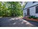 Exterior of a home with a long paved driveway surrounded by a yard with mature trees at 2007 Mount Vernon Pl, Dunwoody, GA 30338