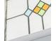 Close up shot of stained glass window with blue, green, and yellow panes at 2007 Mount Vernon Pl, Dunwoody, GA 30338