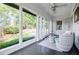 Bright sunroom with wicker furniture, large windows, and views of the green backyard at 2007 Mount Vernon Pl, Dunwoody, GA 30338