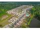 Aerial view of the community with homes, a pond, pool and lots of trees at 2292 Knob Creek Rd, Snellville, GA 30078