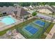 A lovely aerial view of a community pool, pavilion, and pickleball courts with well-manicured landscaping around the whole area at 2292 Knob Creek Rd, Snellville, GA 30078