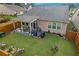 Beautiful backyard with a covered patio, outdoor furniture, and a well-maintained lawn at 2292 Knob Creek Rd, Snellville, GA 30078