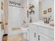Well lit bathroom with shower and vanity and unique African-themed decor on shelves and walls at 2292 Knob Creek Rd, Snellville, GA 30078