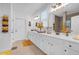 Bright bathroom featuring double sinks, white cabinets, and modern lighting at 2292 Knob Creek Rd, Snellville, GA 30078