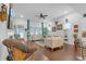 Comfortable living room featuring a ceiling fan, hardwood floors, and bright, natural light at 2292 Knob Creek Rd, Snellville, GA 30078