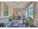 Comfortable sunroom with bright windows, potted plants, and wicker furniture at 2292 Knob Creek Rd, Snellville, GA 30078