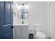 Stylish bathroom with a modern vanity, round mirror, and sleek fixtures at 4167 Oakwood Way, Duluth, GA 30096