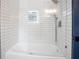 Bathroom with a white tile shower and bath combination at 4167 Oakwood Way, Duluth, GA 30096
