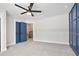 Spacious bedroom with a sleek ceiling fan and stylish blue paneled wall at 4167 Oakwood Way, Duluth, GA 30096