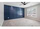 An empty bedroom showcases a striking blue accent wall and a contemporary ceiling fan at 4167 Oakwood Way, Duluth, GA 30096