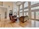 Bright living room with a fireplace, hardwood floors, large windows, and high ceilings at 525 Water Shadow Ln, Alpharetta, GA 30022