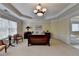 Bright bedroom featuring a tray ceiling, neutral decor, and an ensuite bathroom at 525 Water Shadow Ln, Alpharetta, GA 30022