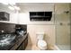 Modern bathroom featuring dual glass vessel sinks, sleek black countertops, and a glass enclosed shower at 7500 Roswell Rd # 18, Sandy Springs, GA 30350