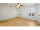 A well lit bedroom with hardwood floors, a ceiling fan, and two windows with bright white shutters at 7500 Roswell Rd # 18, Sandy Springs, GA 30350