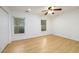 Bright bedroom featuring hardwood floors, a ceiling fan, and two windows offering ample natural light at 7500 Roswell Rd # 18, Sandy Springs, GA 30350