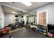 Well-equipped gym with cardio machines, weights, and mirrors for a comprehensive fitness experience at 7500 Roswell Rd # 18, Sandy Springs, GA 30350