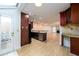 A well-lit kitchen with wood cabinets, stone countertops, and stainless steel appliances overlooks an open living area at 7500 Roswell Rd # 18, Sandy Springs, GA 30350