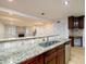 Modern kitchen features stainless steel appliances and granite countertops overlooking the living area at 7500 Roswell Rd # 18, Sandy Springs, GA 30350
