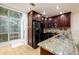 A bright kitchen features granite countertops, stainless steel appliances, and a glass enclosed breakfast nook at 7500 Roswell Rd # 18, Sandy Springs, GA 30350