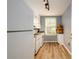 Efficient kitchen featuring white appliances, a window for natural light, and hardwood flooring at 7500 Roswell Rd # 18, Sandy Springs, GA 30350