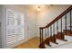 View of the stairway and front entrance; staircase has wood stairs and wrought iron spindles on the railing at 7500 Roswell Rd # 18, Sandy Springs, GA 30350