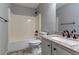 Bathroom featuring granite countertop, tub/shower combo, and tile floors at 1404 Lancaster Ct, Mcdonough, GA 30252