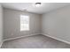 Standard bedroom with gray walls, carpet, one window and a standard ceiling light at 1404 Lancaster Ct, Mcdonough, GA 30252