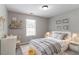 Light-filled bedroom with neutral walls, modern decor, and a comfortable bed, creating a serene space at 1404 Lancaster Ct, Mcdonough, GA 30252