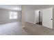 Large bedroom with neutral walls and carpet features a large doorway and support beam at 1404 Lancaster Ct, Mcdonough, GA 30252