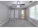 Spacious bedroom featuring neutral walls, carpet, ceiling fan and natural light from the large window at 1404 Lancaster Ct, Mcdonough, GA 30252