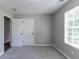 Bedroom featuring a large window, carpet, and two closets at 1404 Lancaster Ct, Mcdonough, GA 30252