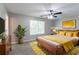 Modern bedroom with a ceiling fan, wooden bed frame, and neutral decor, providing a relaxing atmosphere at 1404 Lancaster Ct, Mcdonough, GA 30252