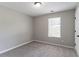 Clean, simple bedroom featuring neutral walls, carpet, and a window with blinds, maximizing natural light at 1404 Lancaster Ct, Mcdonough, GA 30252
