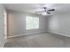 Spacious bedroom featuring neutral walls, carpet, a window, and a ceiling fan at 1404 Lancaster Ct, Mcdonough, GA 30252