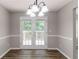 Dining area with French doors leading to a deck, stylish light fixture, and neutral walls, perfect for entertaining at 1404 Lancaster Ct, Mcdonough, GA 30252
