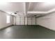 Spacious garage with two garage doors, painted floors, and overhead lighting at 1404 Lancaster Ct, Mcdonough, GA 30252