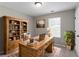 Charming home office with custom wooden desk, bookshelves, and decor, creating a perfect workspace at 1404 Lancaster Ct, Mcdonough, GA 30252