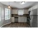 Charming kitchen features stainless steel appliances, granite countertops, and sleek backsplash at 1404 Lancaster Ct, Mcdonough, GA 30252
