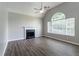 Open living room with soaring ceilings, fireplace, sleek floors, and bright windows, maximizing natural light at 1404 Lancaster Ct, Mcdonough, GA 30252