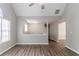 Bright living room featuring wood flooring and large windows at 1404 Lancaster Ct, Mcdonough, GA 30252