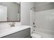 Bathroom featuring a sleek vanity with quartz countertop, modern fixtures, and shower-tub at 1947 Drew Nw Dr, Atlanta, GA 30318