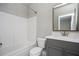 Well-lit bathroom with a modern vanity, large mirror, and shower-tub combo at 1947 Drew Nw Dr, Atlanta, GA 30318