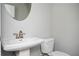 Powder room featuring a pedestal sink, oval mirror, and neutral wall paint at 1947 Drew Nw Dr, Atlanta, GA 30318