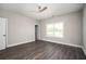 Bedroom with a ceiling fan, neutral paint, wood floors, bright trim and a large window at 1947 Drew Nw Dr, Atlanta, GA 30318