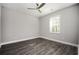 Bedroom with wood-look flooring, neutral paint, a large window, and a ceiling fan at 1947 Drew Nw Dr, Atlanta, GA 30318