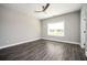 Bedroom with wood-look flooring, neutral paint, a large window, and a ceiling fan at 1947 Drew Nw Dr, Atlanta, GA 30318