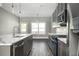 Modern kitchen with stainless steel appliances, a stylish island, and an inviting view to the outdoors at 1947 Drew Nw Dr, Atlanta, GA 30318