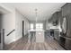 Open-concept kitchen highlighting gray cabinets, a central island with pendant lighting, and stainless steel appliances at 1947 Drew Nw Dr, Atlanta, GA 30318
